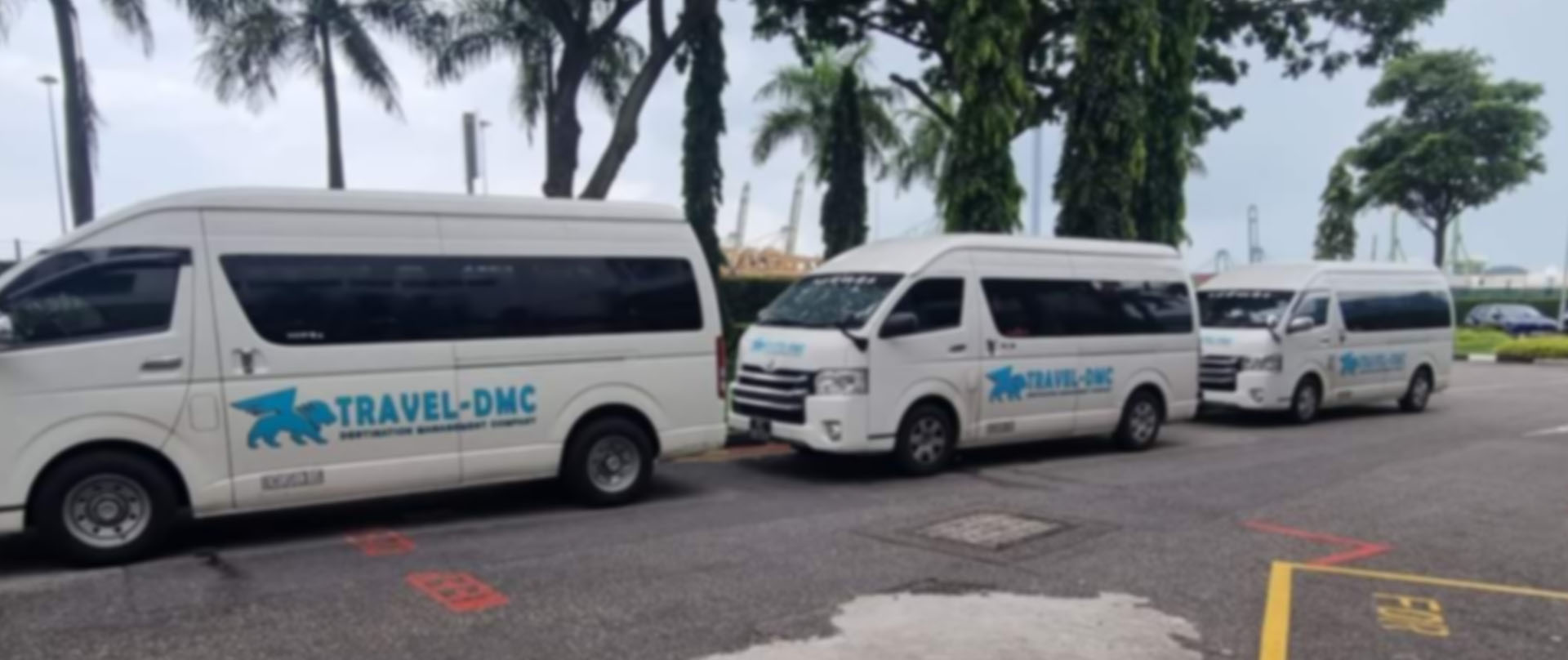 Travel DMC vans at a depot in Singapore